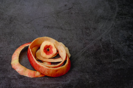 There is no skin on the apple pulp, and the remaining apple skin is a hollow apple.with black backgroundの写真素材