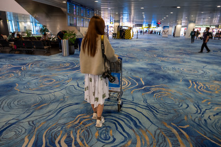 Changi, Singapore - October 24, 2024: Tourists transiting at Singapore Changi Airport. Changi Airport is one of the largest airports in the world, interior sceneの写真素材