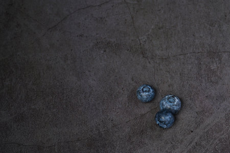 Close-up of blueberries on dark background. Close-up of ripe juicy blueberries filling the frameの写真素材