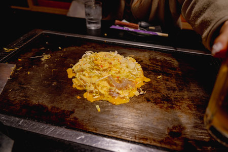 Okonomiyaki is one of Osaka's famous foods.Teppanyaki is a Japanese cuisine that uses an iron griddle to cook food.の写真素材