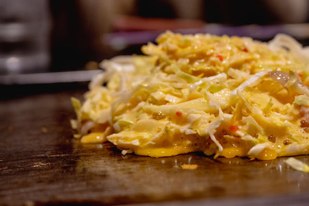 Okonomiyaki is one of Osaka's famous foods.Teppanyaki is a Japanese cuisine that uses an iron griddle to cook food.の写真素材