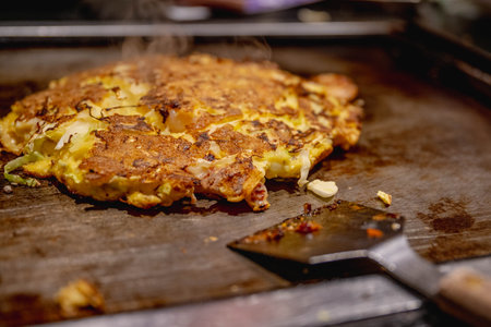 Okonomiyaki is one of Osaka's famous foods.Teppanyaki is a Japanese cuisine that uses an iron griddle to cook food.の写真素材