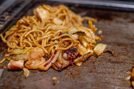 Okonomiyaki is one of Osaka's famous foods. Teppanyaki is a Japanese cuisine that uses an iron griddle to cook food.の写真素材