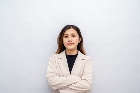 Young asian woman, professional entrepreneur standing in office clothing, looking confident, white backgroundの写真素材