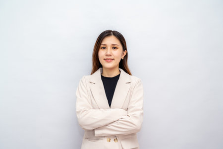 Young asian woman, professional entrepreneur standing in office clothing, looking confident, white backgroundの写真素材