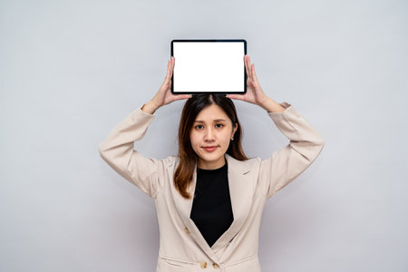 Woman Presenting Digital Tablet for Corporate Use,Professional Woman Holding a Blank Tablet for...