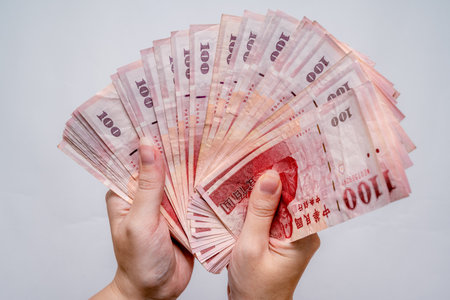 Holding New Taiwan Dollar, Taiwan banknote, symbol of wealth and successの写真素材