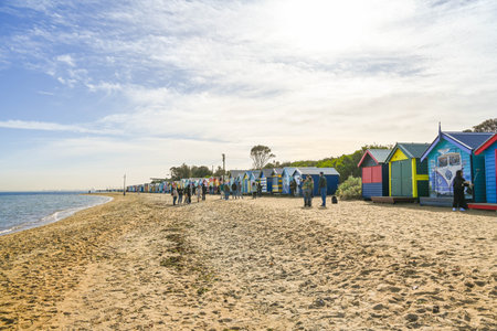 MELBOURNE, VICTORIA, AUSTRALIA - JUNE 1, 2023: People walking on Brighton Beach, Melbourne, Australiaの写真素材