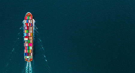 Aerial top view container ship in export and import business and logistics. Shipping cargo to harbor by crane.の写真素材