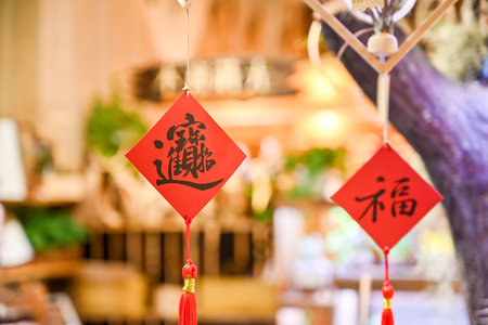 Taiwan May 30 2025: Festive Chinese New Year interior with red spring couplets, lucky knots and plants inside wood workshop, illustrating cultural holiday atmosphereの写真素材
