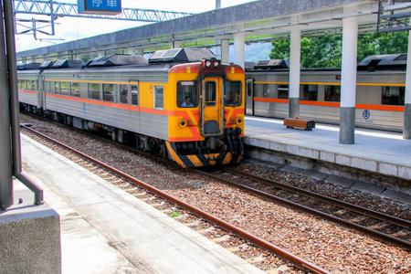 Taiwan May 21, 2024: A scenic view of a train at Fuli Station in Hualien, Taiwan, with clear sky and mountain background. Ideal for travel, transport, and rural tourism themes. Fuli Station and Train in Taiwanの写真素材