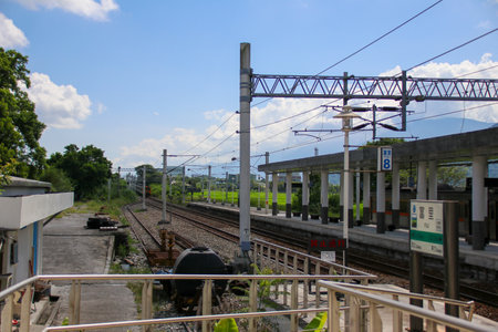 Taiwan May 21, 2024: A scenic view of a train at Fuli Station in Hualien, Taiwan, with clear sky and mountain background. Ideal for travel, transport, and rural tourism themes. Fuli Station and Train in Taiwanの写真素材