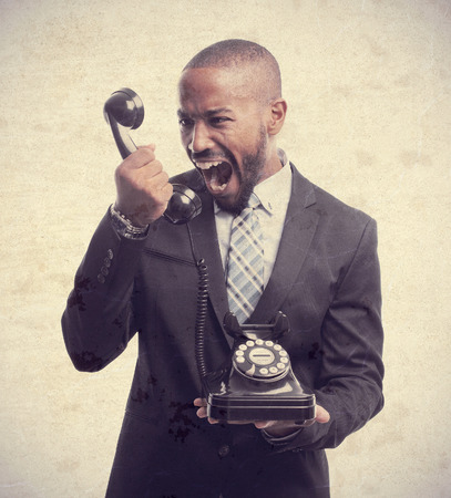 young cool black man shouting at phoneの写真素材