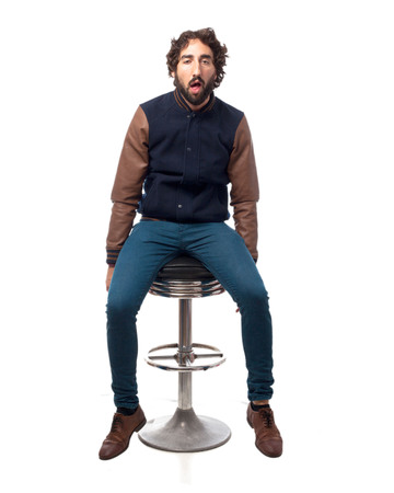 boring young man with bar stoolの写真素材