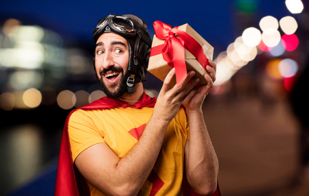 crazy super hero with a giftの写真素材