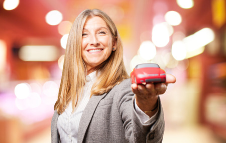 senior beautiful woman with car toyの写真素材