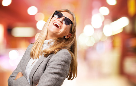 senior beautiful woman laughing with sand glassesの写真素材