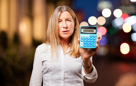 senior beautiful woman with calculatorの写真素材