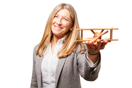 senior beautiful woman with wooden planeの写真素材