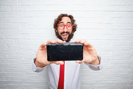 crazy businessman expressing a concept. brick wall backgroundの写真素材