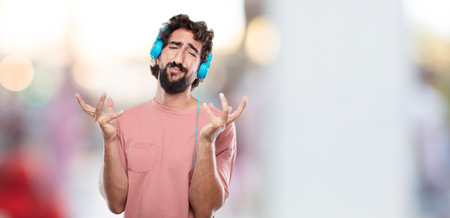 young bearded man looking stressed and frustrated, looking upwards and holding both hands open in front expressing dismay and disbelief.の写真素材