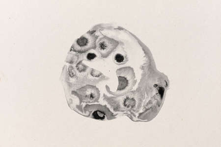black ink shape on water color paper textured background