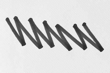 black ink shape on watercolor paper textureの写真素材