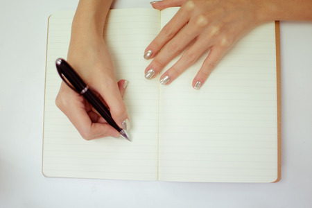 hands with pen writing on paperの写真素材