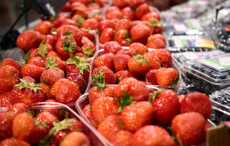 Selective focus. Top view of strawberry in the baskets, ready for sell in the fruit store. Concept...