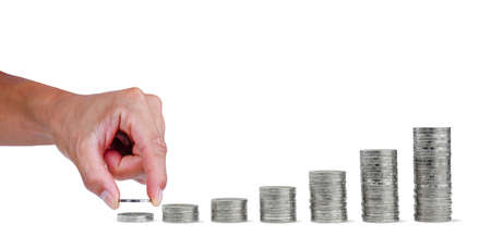 Money saving. Hand holding a coin money in for saving money. Business growth and success on white...