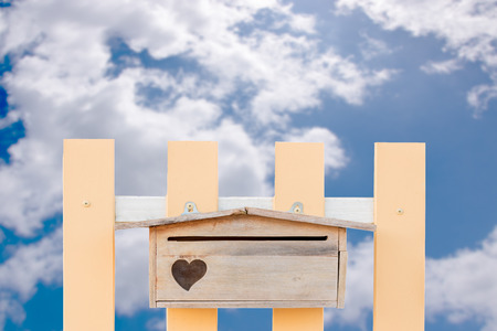 postbox wooden fence background is the sky.の写真素材