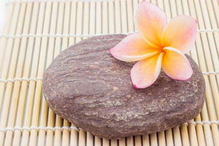 Plumeria on wood bamboo mat and wood backgroundの写真素材