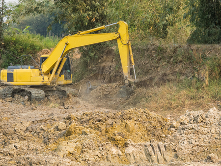Excavator working digging a large hole.