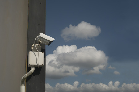 CCTV on the wall with the sky on cloudy days