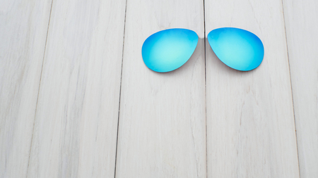 concept sunglasses on a white wooden table.の写真素材