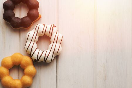 top view donuts on white wood background.の写真素材