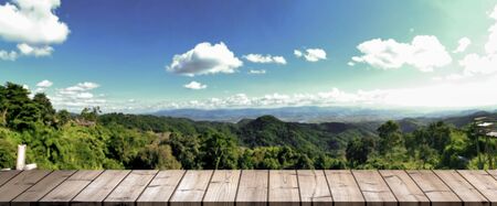 wooden table top with the mountain and blue sky.
