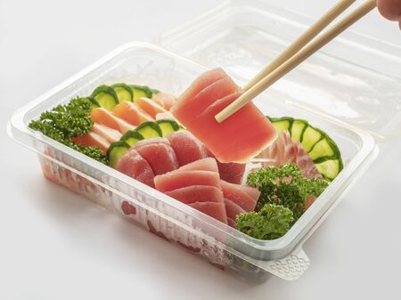 set of sushi in a plastic box, delivered home ready to eat fast healthy food, isolated on white.の写真素材