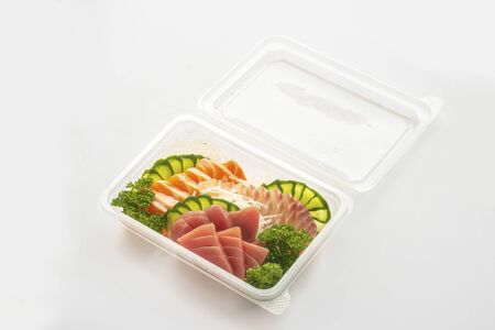 set of sushi in a plastic box, delivered home ready to eat fast healthy food, isolated on white.の写真素材