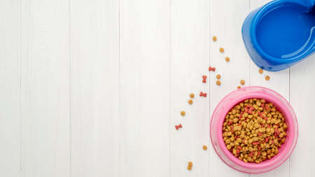 Dog food on white wooden table