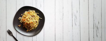 Spaghetti and fork on wood tableの写真素材