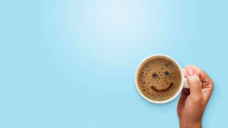 froth milk foam smiles in a cup of coffee in morning.