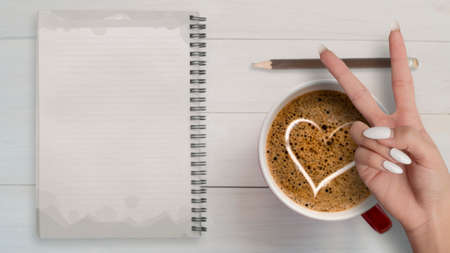 Top view of empty note   heart sign with coffee hand victoryの写真素材