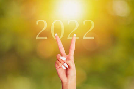 symbol victory hand on the 2022 background of a surise.