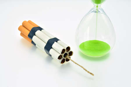 Dynamite packet made from cigarettes and an hourglass measuring timeの写真素材