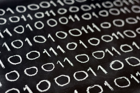 The numbers zero and one, written on a blackboard, binary systemの写真素材