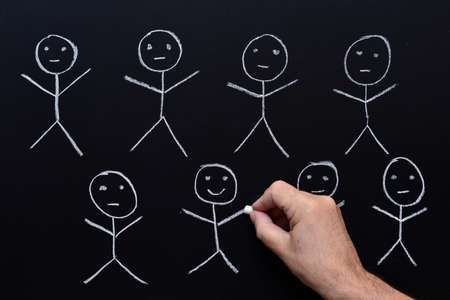 Group of puppets drawn by hand with chalk on a blackboardの写真素材