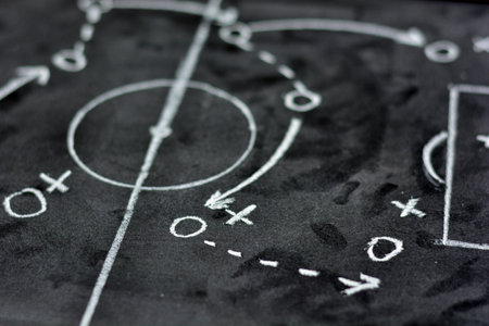 Soccer game strategy hand drawn with chalk on a blackboardの写真素材