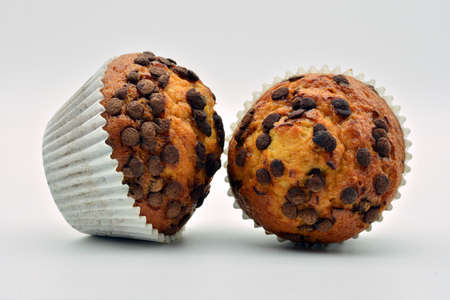 Fluffy muffins with chocolate chips, isolated on white backgroundの写真素材