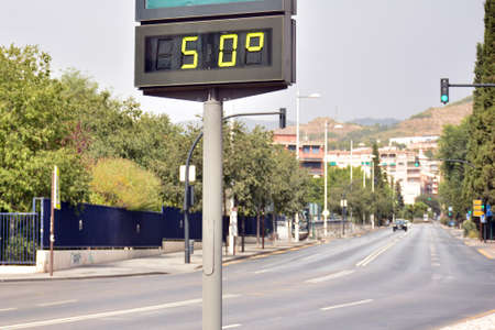 Street thermometer marking 50 degrees celsius in summer